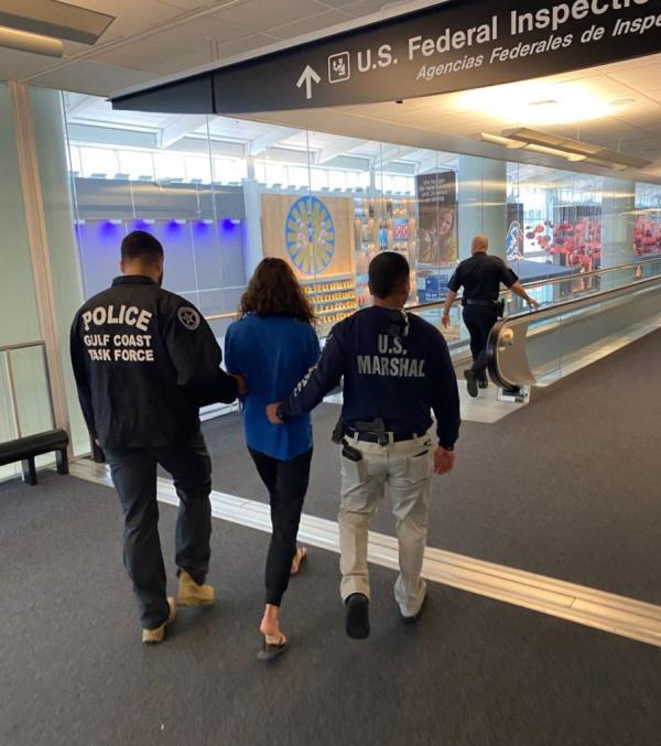 Kaitlin Marie Armstrong being led through the airport by agents. She is accused of murdering Anna Moriah Wilson and was arrested in Costa Rica.