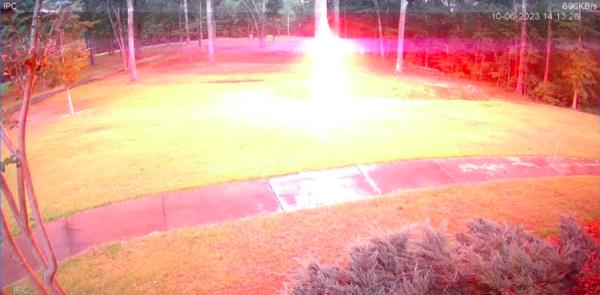 Lightning striking a tree. (via security camera)