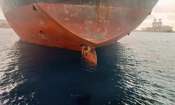 Nigerian stowaways sitting on a cargo ship's rudder