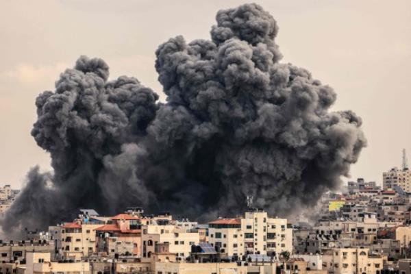 A plume of smoke rises in the sky of Gaza City during an Israeli airstrike on October 9, 2023. Israel relentlessly pounded the Gaza Strip overnight and into October 9 as fighting with Hamas co<em></em>ntinued around the Gaza Strip, as the death toll from the war against the Palestinian militants surged above 1,100. (Photo by MAHMUD HAMS / AFP) (Photo by MAHMUD HAMS/AFP via Getty Images)