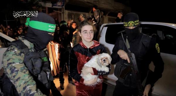 Mia Leimberg and her dog are escorted by Hamas terrorists as she is handed over to members of the Internatio<em></em>nal Committee of the Red Cross on Nov. 28, 2023.