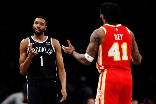 Mikal Bridges #1 of the Brooklyn Nets celebrates scoring during the second half as Saddiq Bey #41 of the Atlanta Hawks reacts at Barclays Center.