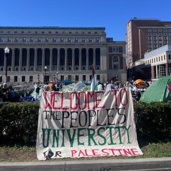 Sign in front of the encampment reading 