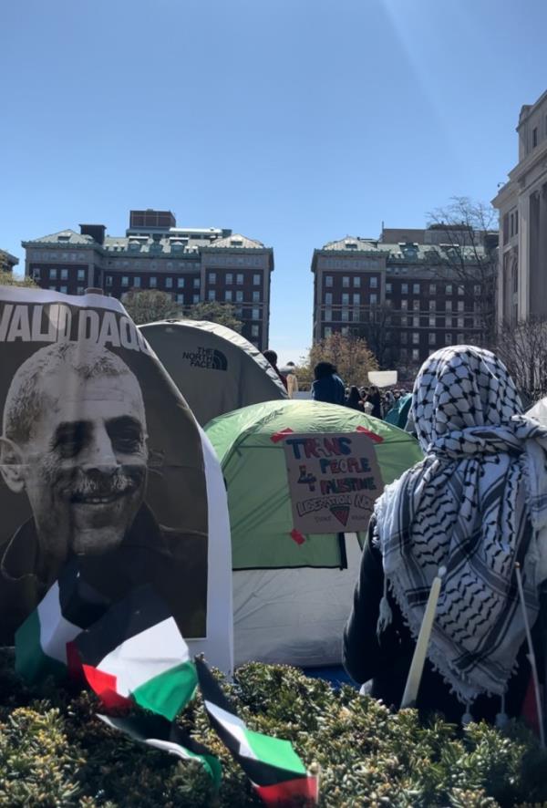 Trans people for Palestine poster on a tent