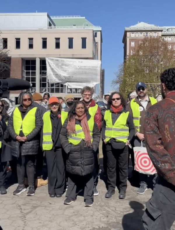 Staff in yellow vests at the protest