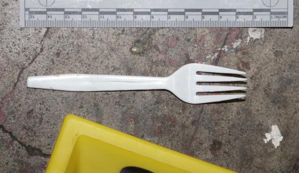 White plastic fork seen after being taken into evidence by police 