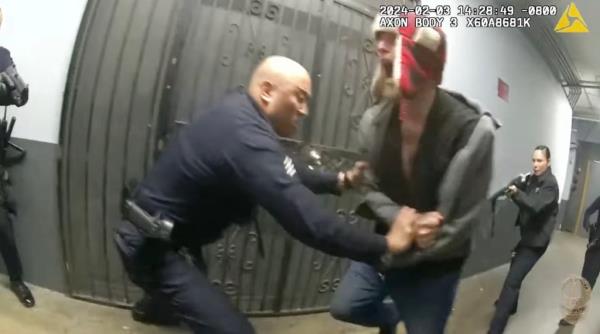 Screenshot from LAPD body camera video shows police wrestling with Jason Maccani