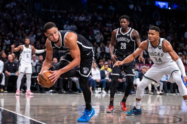 Nets guard Ben Simmons (10) saves a ball in the first half against the Milwaukee Bucks