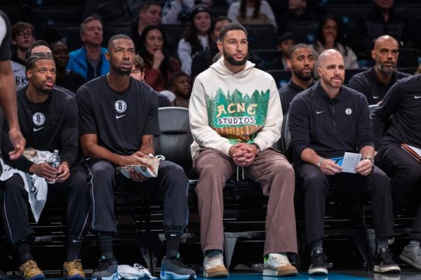 Ben Simmons #10 of the Brooklyn Nets sits on the bench in plain clothes