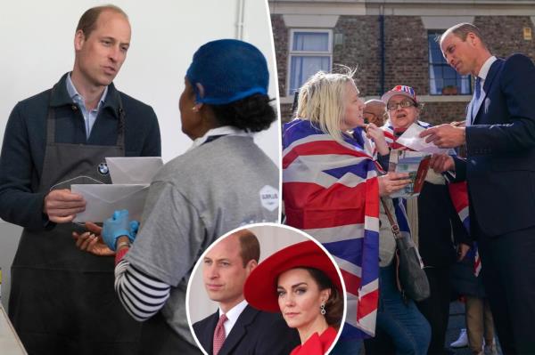 Prince William is given cards for his wife by volunteer Rachel Candappa during a visit to Surplus to Supper, in Sunbury-on-Thames. 