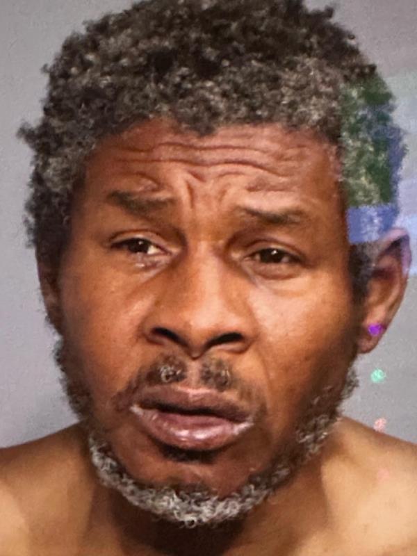 Man with a beard, identified as Alvin Doris, following two young boys selling candy on a subway platform at Broadway-Lafayette station.