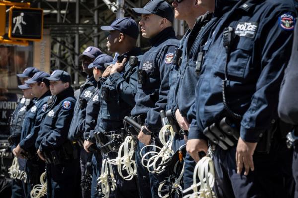 NYPD officers forming a protective wall around Deputy Commissio<em></em>ners Michael Gerber and Kay Daughtry during a pro-Palestine protest press co<em></em>nference at Columbia University