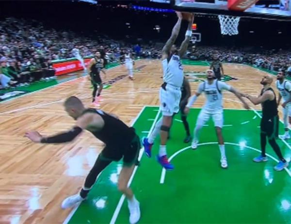 Celtics center Kristaps Porzingis appeared to  tweak his leg in the fourth quarter of Boston's Game 2 win over the Mavericks  at TD Garden on Sunday, June 9, 2024. 