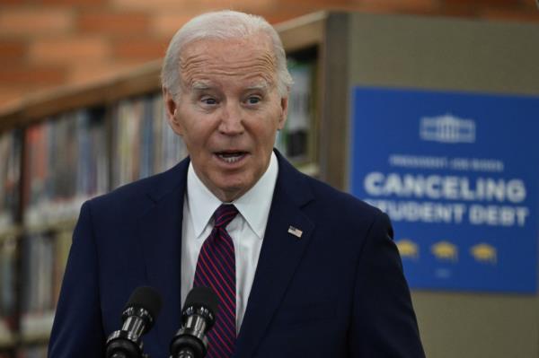 Joe Biden speaking at a podium with micropho<em></em>nes in front of him at an event announcing student debt cancellation.