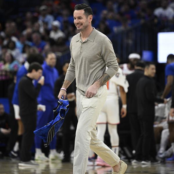 Former Orlando Magic guard JJ Redick, center, leaves the court after being ho<em></em>nored by the team during the first half of an NBA basketball game against the New York Knicks, Wednesday, Feb. 14, 2024, in Orlando, Fla.  