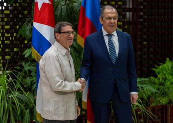 Russian Foreign Minister Sergey Lavrov (R) and Cuba's Minister of Foreign Affairs, Bruno Rodriguez, shake hands during a meeting in Havana on April 20, 2023.