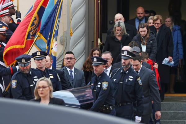 Boston police officers carry the casket of O'Keefe on Feb. 7, 2022.