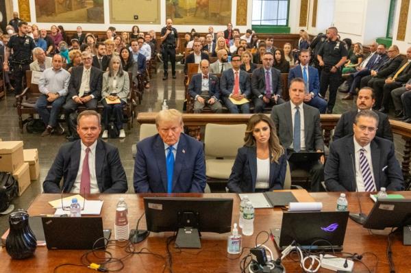 Former President Do<em></em>nald Trump speaks to the media as he arrives at court Monday, Oct. 2, 2023.