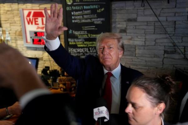 Former President Do<em></em>nald Trump greets supporters at the Treehouse Pub & Eatery, Wednesday, Sept. 20, 2023, in Bettendorf, Iowa. (AP Photo/Charlie Neibergall)