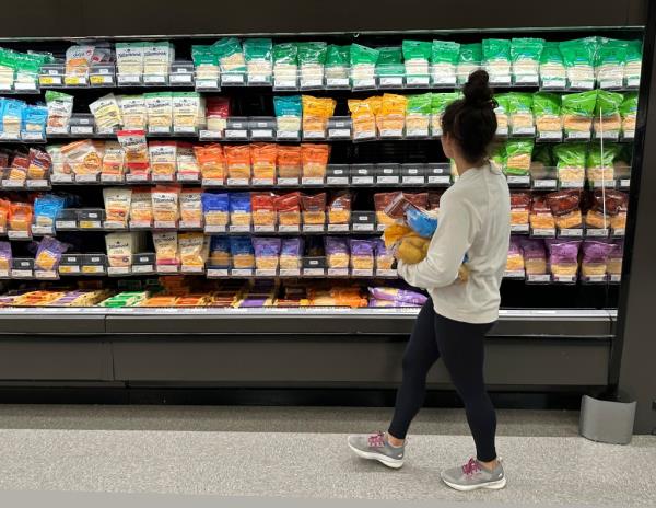 A shopper peruses cheese offerings at a Target store 