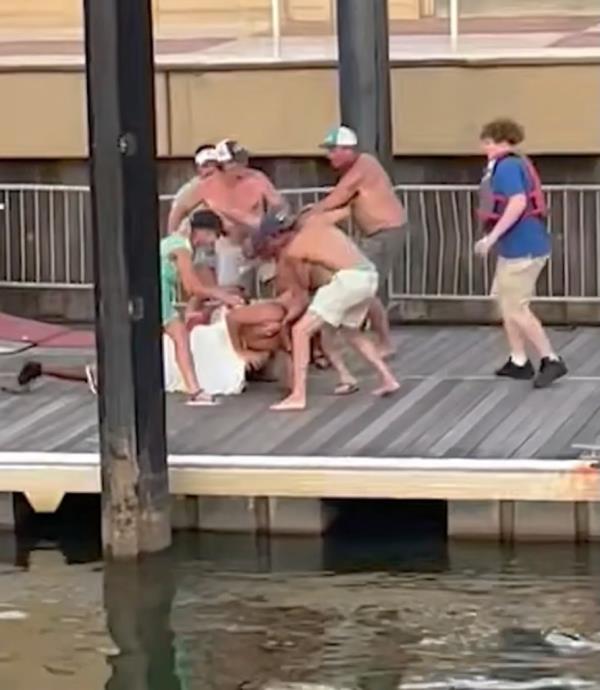 People fighting Pickett on the dock. 