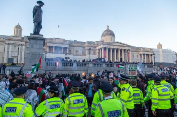 Mandatory Credit: Photo by Thabo Jaiyesimi/SOPA Images/Shutterstock (14150470j) Police co<em></em>ntain Pro-Palestinian protesters in Trafalgar Square during the demonstration. Pro-Palestinian protesters in London, supporters took to the streets to denounce Israel's bombardment of Gaza Strip in retaliation to the attack by Hamas. Pro-Palestinian protest in London, UK - 14 Oct 2023