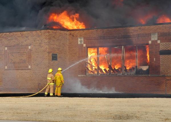 Firefighters battle a fully-engulfed, empty school building fire in Oklahoma.