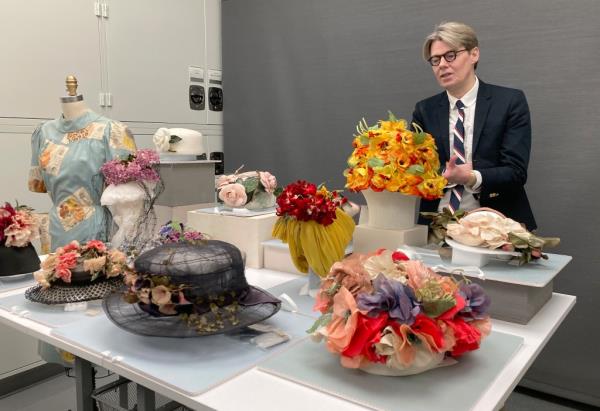 Curator in Charge Andrew Bolton with a floral design featured in the exhibition. 