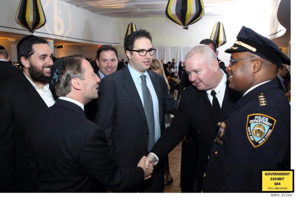 Jona Rechnitz shaking hands at an event.