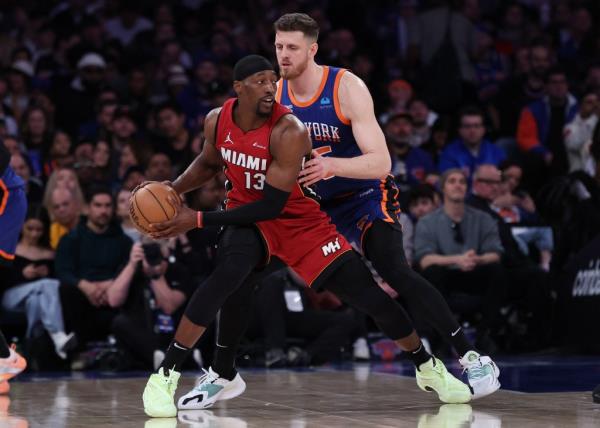 Miami Heat center Bam Adebayo (13) shields the ball from New York Knicks center Isaiah Hartenstein (55) during the second half at Madison Square Garden. 