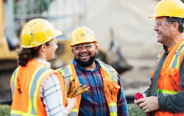 A group of three multi-ethnic workers at a co<em></em>nstruction site