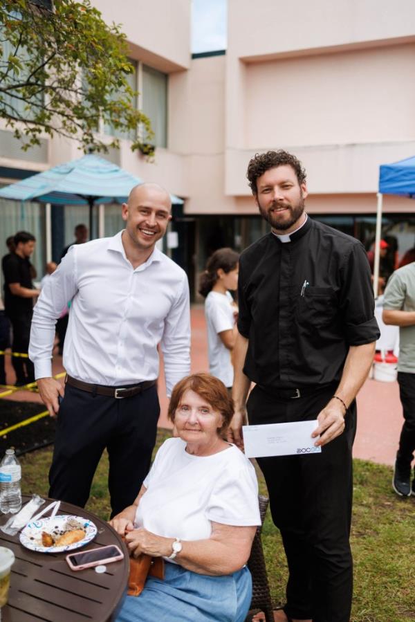 DocGo CEO Anthony Capone attends a lunch event for asylum seekers in with Rev. Daniel QUinn and Sister Patricia Lynch in Albany, Aug. 16, 2023.