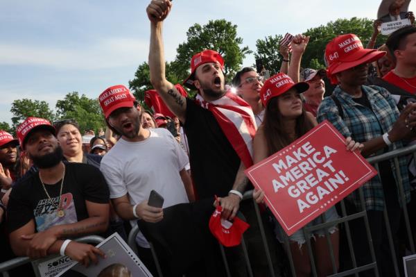 Supporters of former President Do<em></em>nald Trump watch as he holds a rally in the historical Democratic district of the South Bronx on May 23, 2024 in New York City