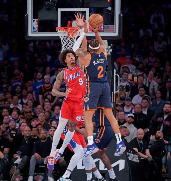 New York Knicks guard Miles McBride #2 hits a shot over 76ers Kelly Oubre Jr. in the fourth quarter April 22, 2024.