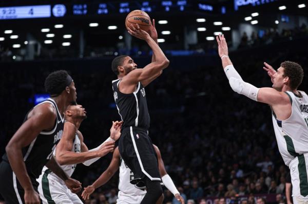 Brooklyn Nets forward Mikal Bridges (1) shoots the ball as Milwaukee Bucks center Brook Lopez (11) defends during the first quarter.