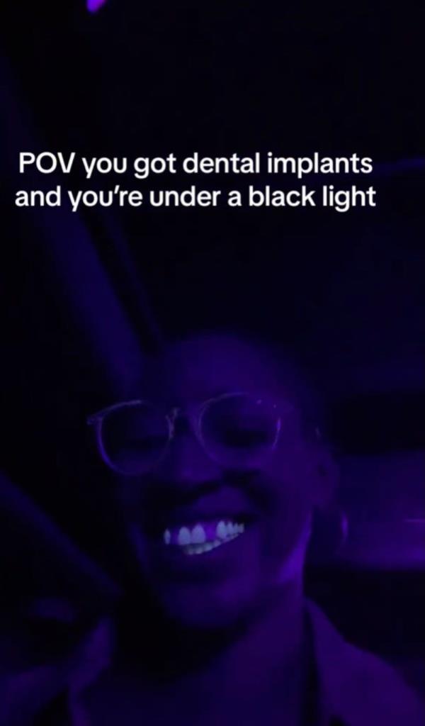 Her implants glowed brightly while her natural teeth did not.