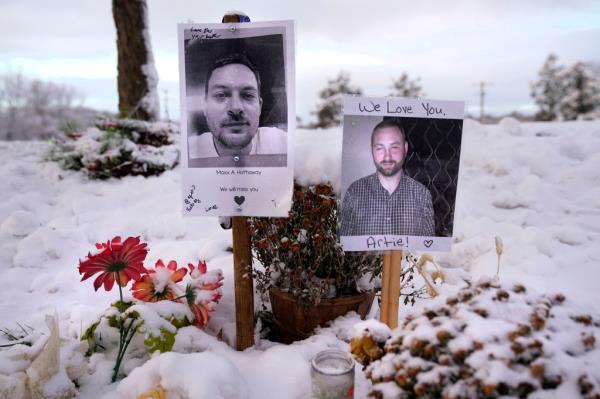 Pictures of two of the victims at a makeshift memorial to the shooting.