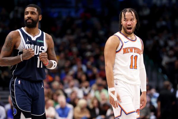 Jalen Brunson #11 of the New York Knicks talks to Kyrie Irving #11 of the Dallas Mavericks in the first half at American Airlines Center.