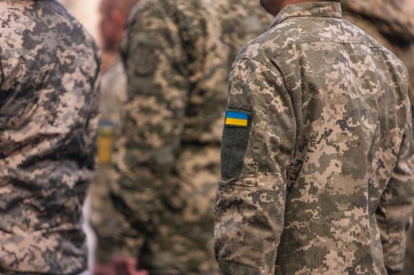 Soldier's uniform detail showing Ukrainian flag in tribute to fallen in Ukraine war ceremony in Toledo, Castilla-La Mancha, Spain.