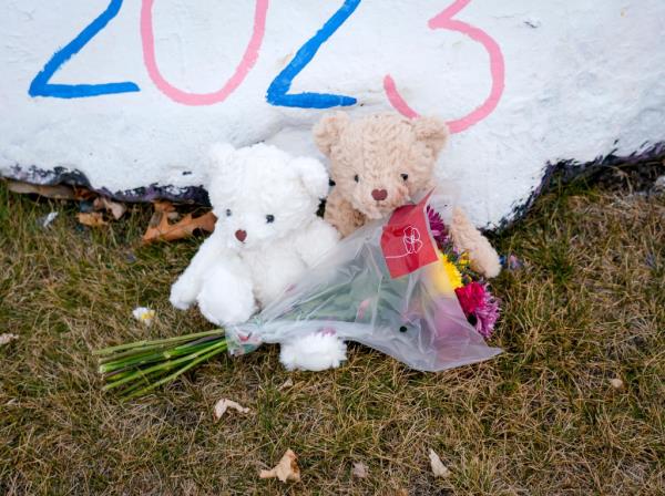 A pair of stuffed animals sit with flowers on the grounds of the Perry High School on Friday, Jan. 5, 2024, in Perry, Iowa, the day after a shooting. 