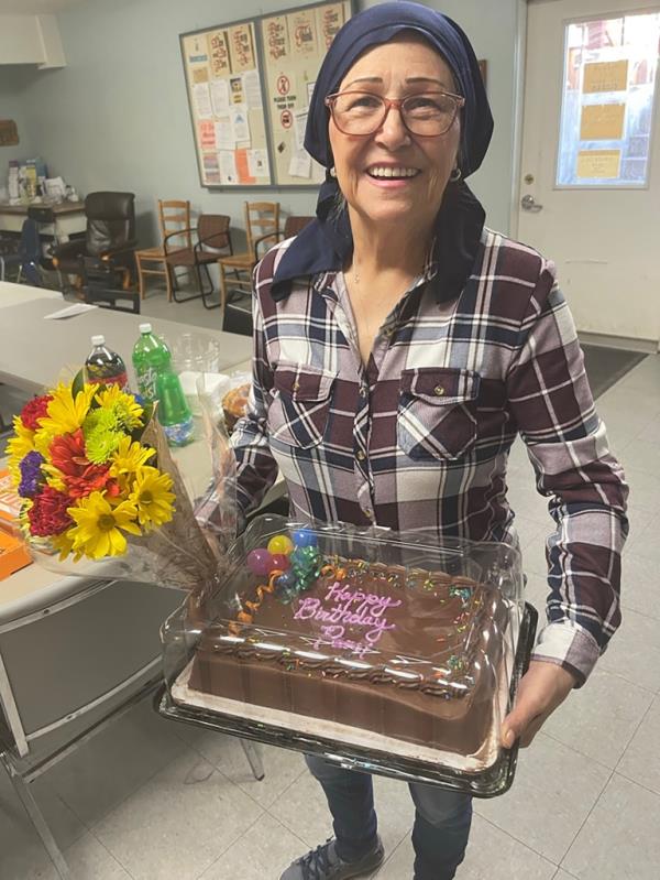 Pam Hemphill holding a cake.