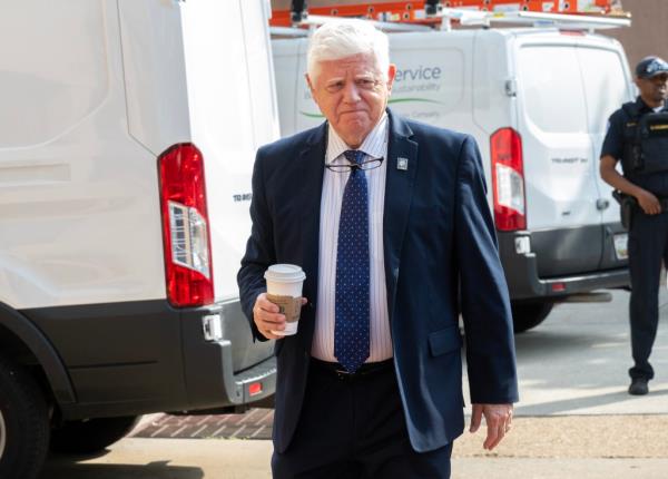 US Representative John B. Larson in a suit holding a coffee cup, arriving for a meeting at the Democratic Natio<em></em>nal Committee Headquarters