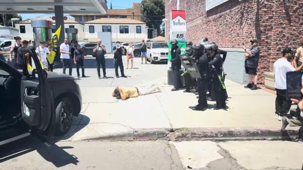 The driver, wearing a mask and yellow shirt, got out of the car first and raised his hands in the air before surrendering.