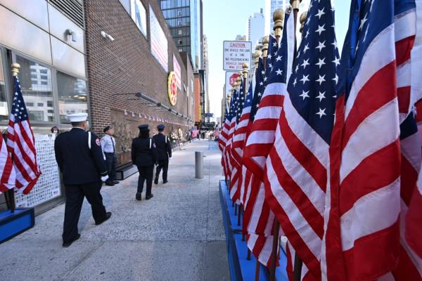 FDNY Engine 10 Ladder 10 9/11 Memorial wall with American flags.