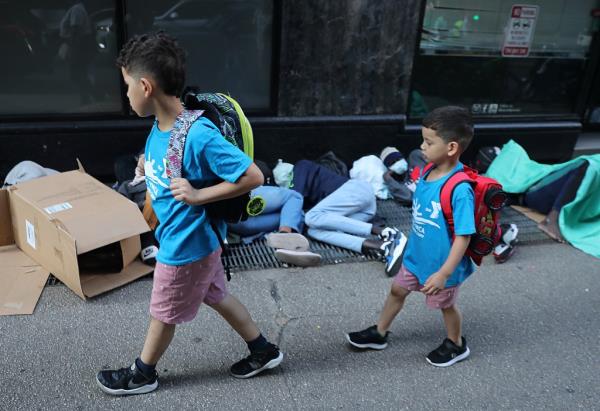 Two young migrant kids walking