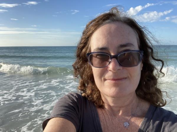 Alisa Newman taking a selfie at the beach before leaving Florida to retire in Delaware