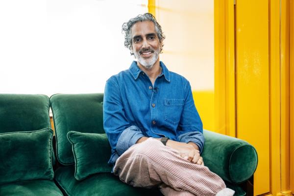 Amar Lalvani sitting on a green couch at The Manner Hotel in Manhattan, photographed on October 4, 2024 by Emmy Park for NY Post