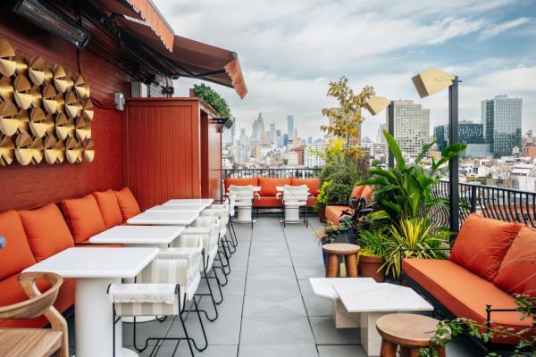 A rooftop patio with tables, chairs, and plants at The Manner Hotel in Manhattan, taken on October 4, 2024