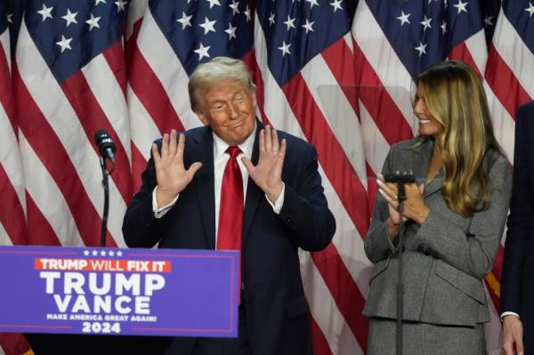 Trump speaks to supporters as former first lady Melania Trump watches at the Palm Beach County Co<em></em>nvention Center during an election night watch party, Wednesday, Nov. 6, 2024, in West Palm Beach, Fla.