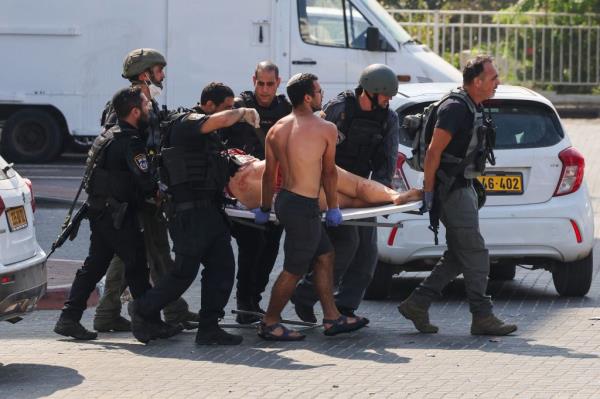 An injured person getting carried on a stretcher after a Hamas rocket attack in Ashkelon.